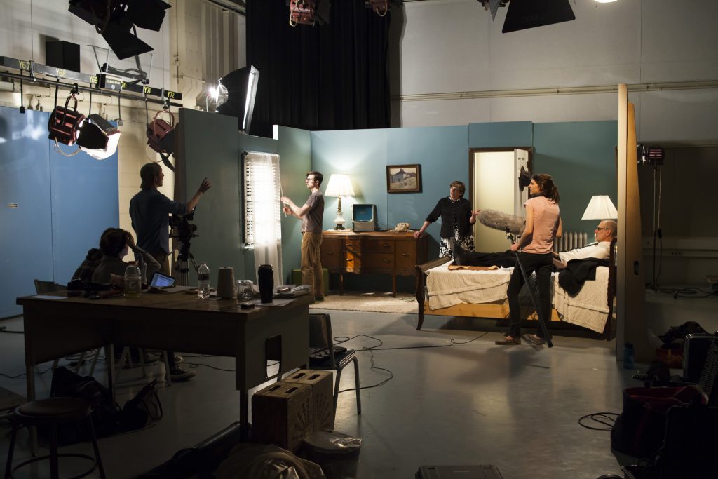 A small student film crew films a dramatic scene in Studio D in Vilas Hall.