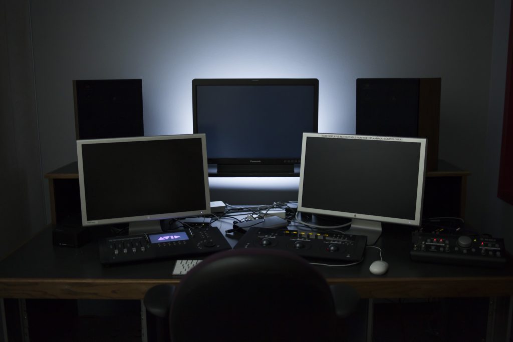 An advanced editing suite, with editing, scopes, and color reference monitors, as well as speakers and control surfaces.