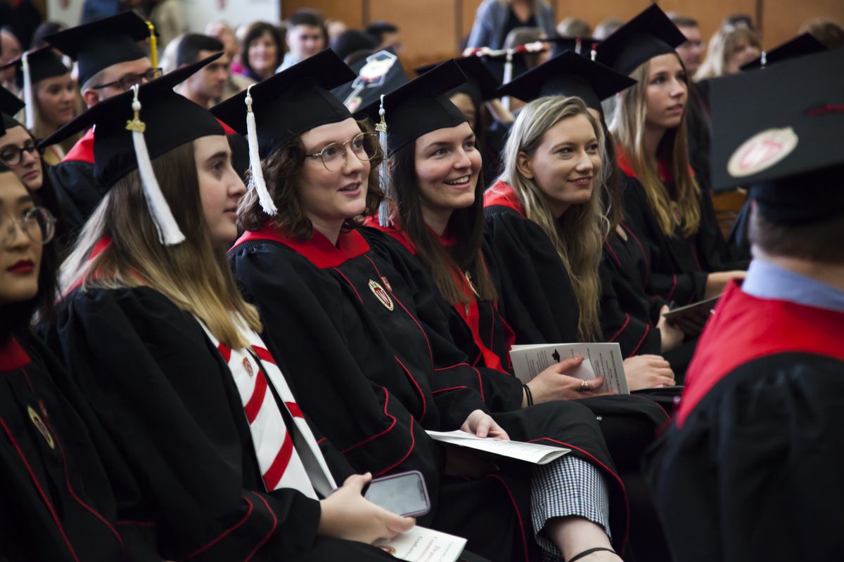 Comm Arts graduates in caps and gowns attend the 2019 Communication Arts Graduation