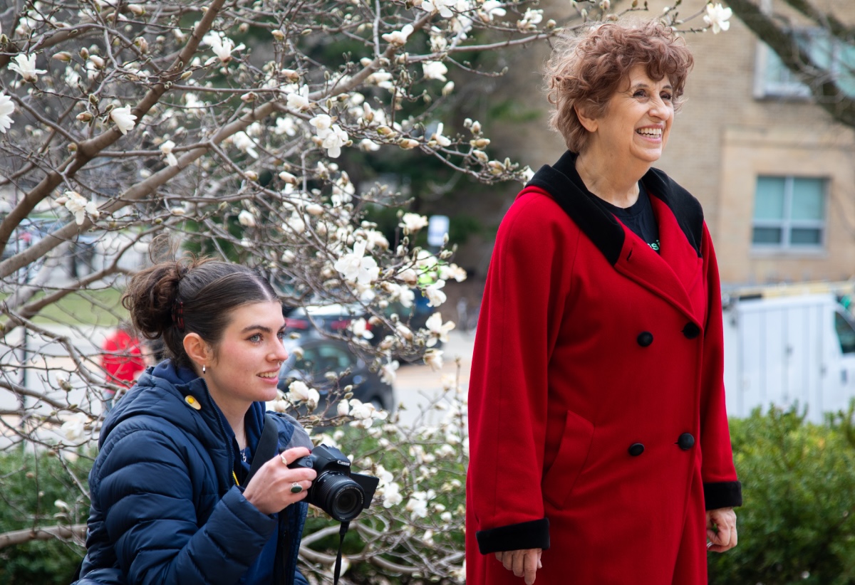 Gwen McMahon (left) with a camera documenting the Wisconsin Film Festival volunteer team. Left, Terry Kerr who organizes venues and volunteers. 