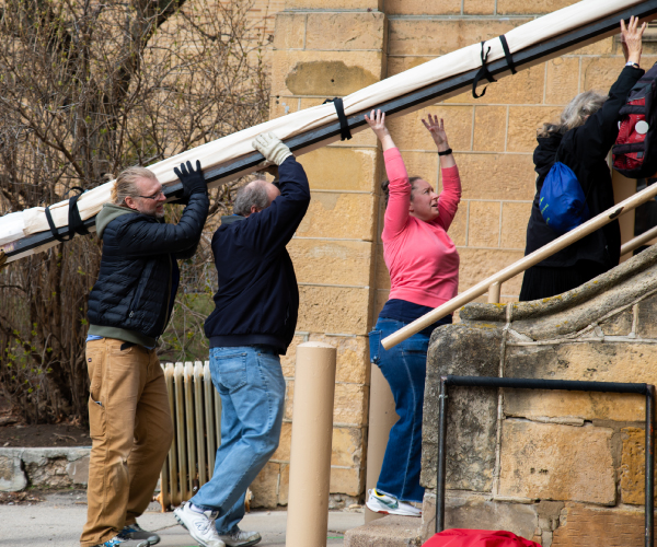 Wisconsin Film Festival volunteers loading in a screen to Music Hall.