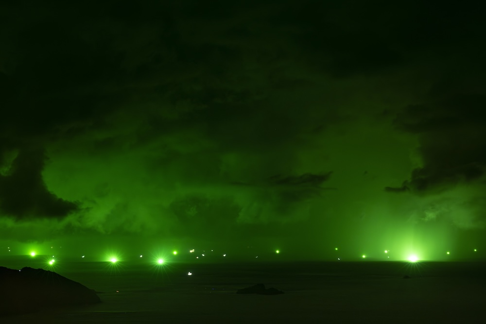 Green lights used for squid fishing in eastern Asia seen in the distance.